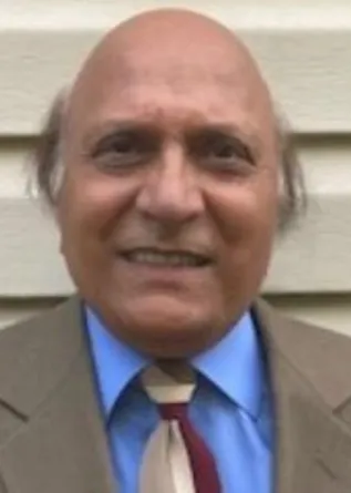 Shanti Swarup smiling confidently at the camera.