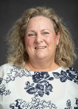 Connie Koski smiling confidently at camera