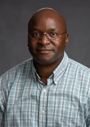 Nyachwaya smiling confidently at camera