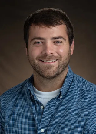 O'Shea smiling confidently at camera