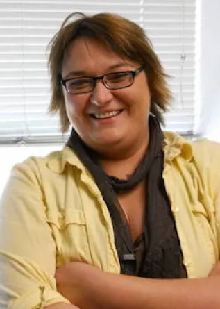 Verena Theile smiling confidently at camera.