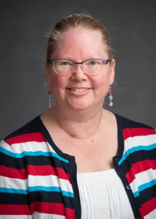 Deona McEnery smiling confidently at camera.