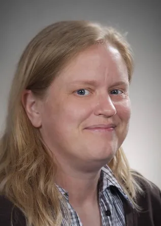 Jamee Larson smiling confidently at camera.