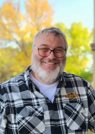 Mitch smiling at the camera.