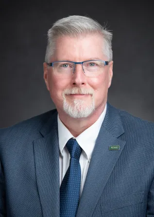 Cooley smiling confidently at camera