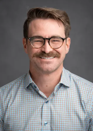 Heath smiling at the camera