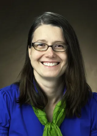 Marcela smiling at the camera