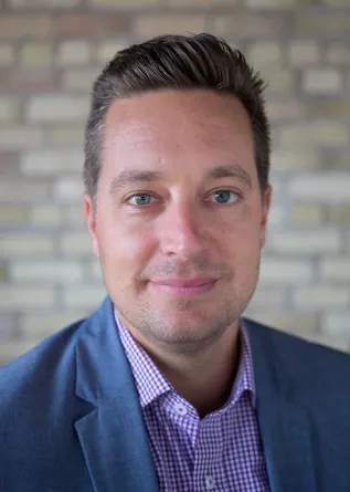 Fischer smiling confidently at camera