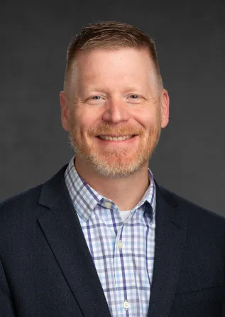 Dr. Briggs smiling confidently at camera.