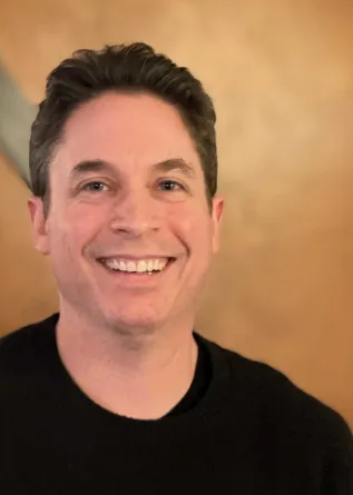 Dr. Pemstein smiling confidently at camera.