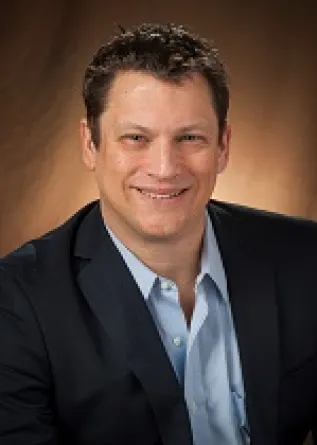 Hilmert smiling confidently at camera