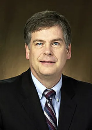 Webster smiling confidently at camera