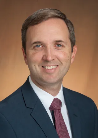 Beck smiling confidently at camera