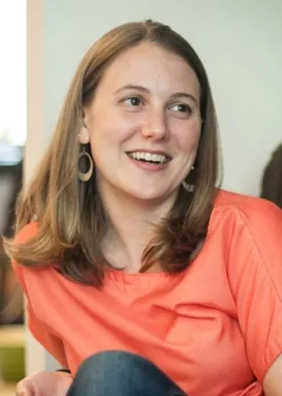 Kristen is smiling at the camera