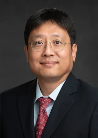 Bong-Jin Choi smiling confidently at camera.