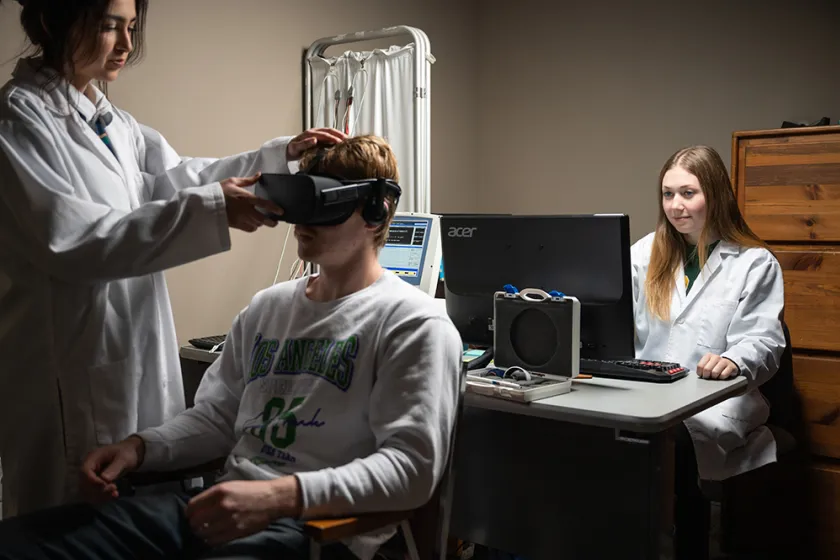 students performing a vision test