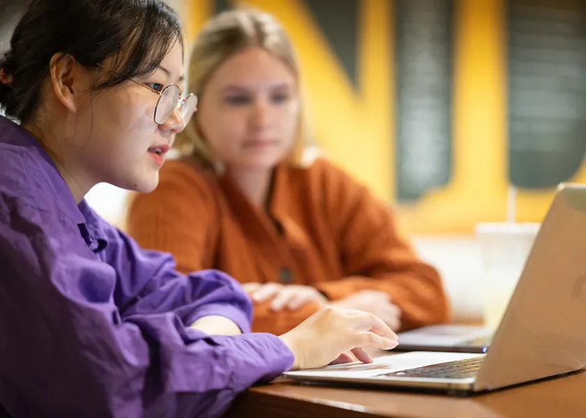 students studying together with a laptop