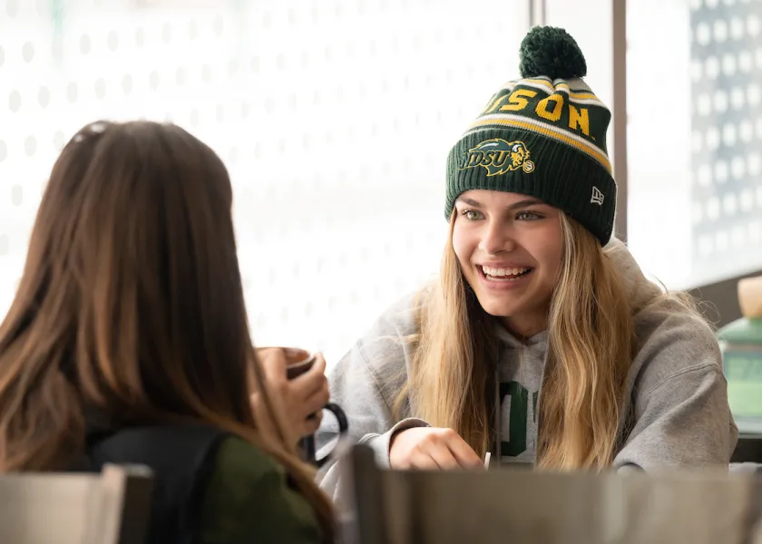 Photo of NDSU students talking in dining center