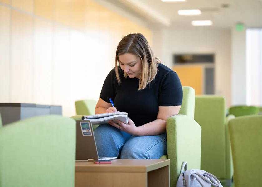 Grace Schmidt writing in notebook