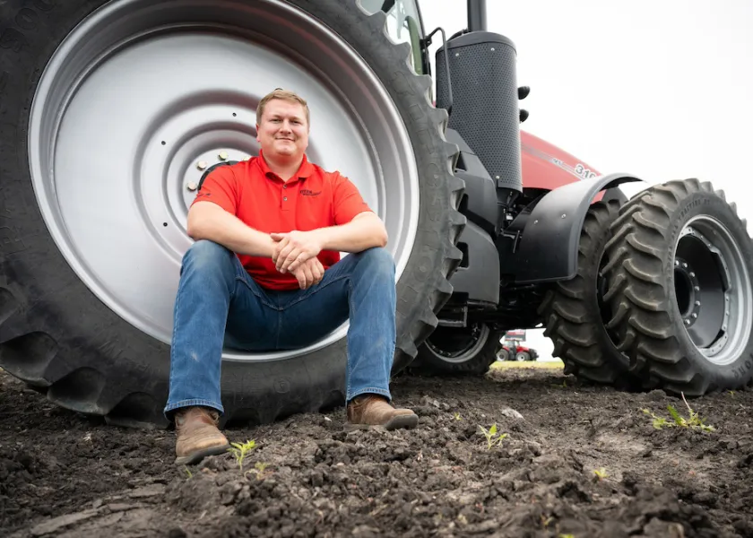 landon overbo sitting in front of a tractor