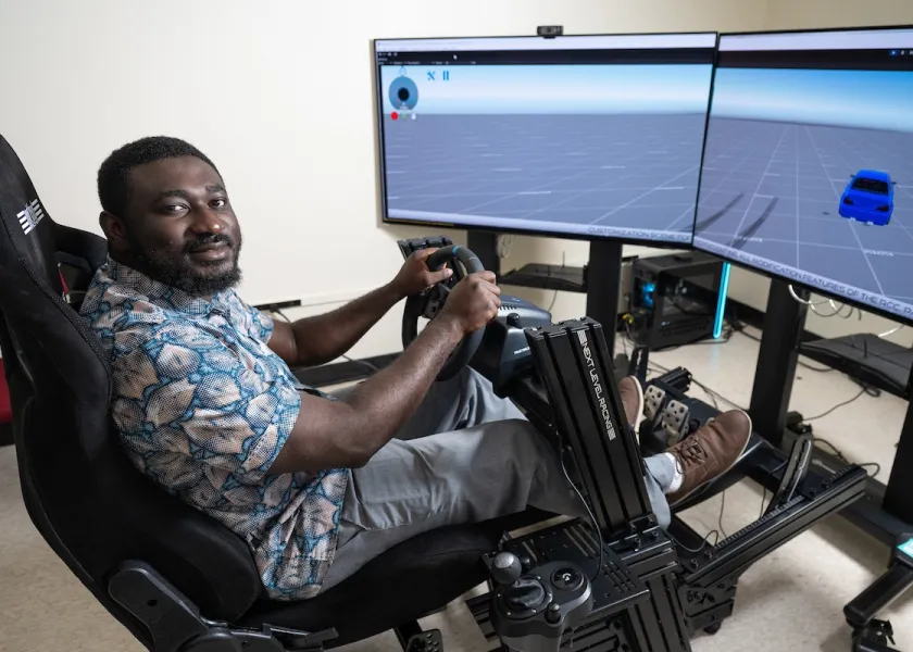 A photo of NDSU professor Armstrong Aboad at a VR research station