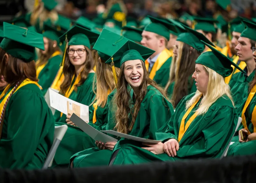 Students interact during the NDSU fall commencement ceremony