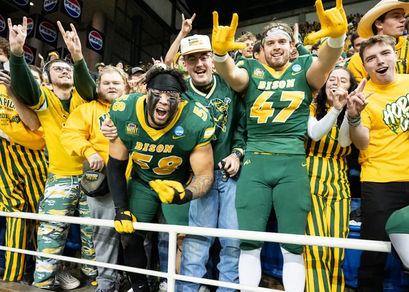 bison football players celebrating with fans
