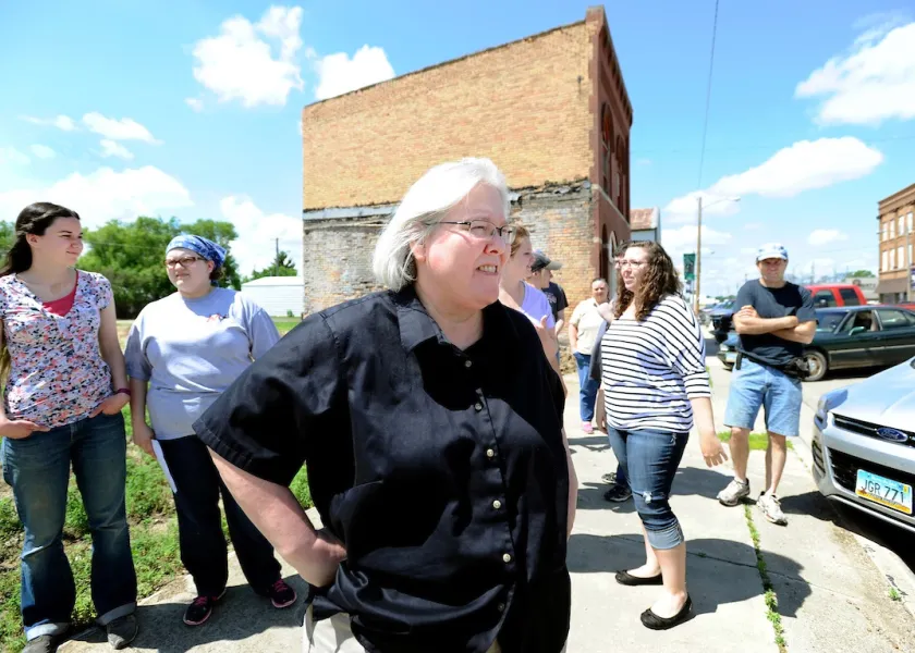 NDSU professor Angela Smith standing on a small-town North Dakota sidewalk with students