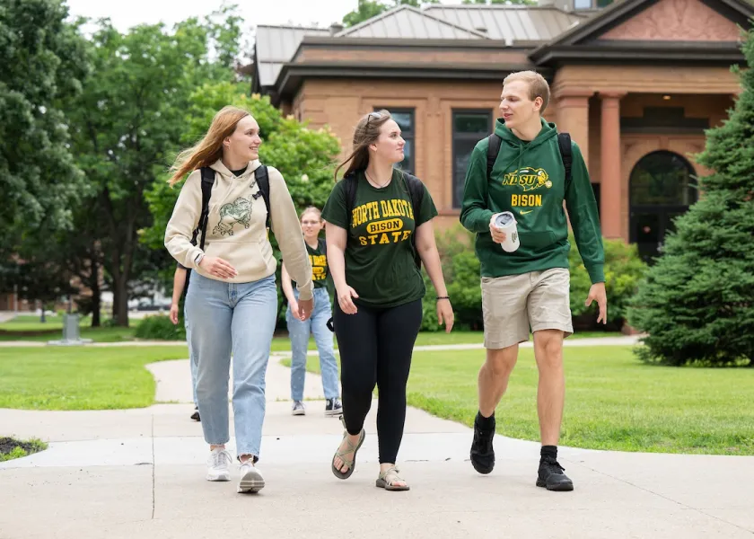 three NDSU students walking on campus