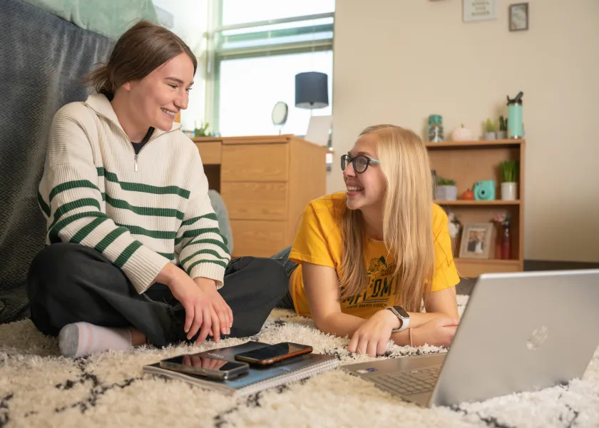 two roommates hanging out in their dorm room