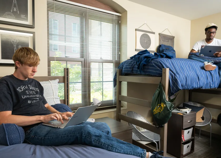 Two residents working in their room at Churchill.