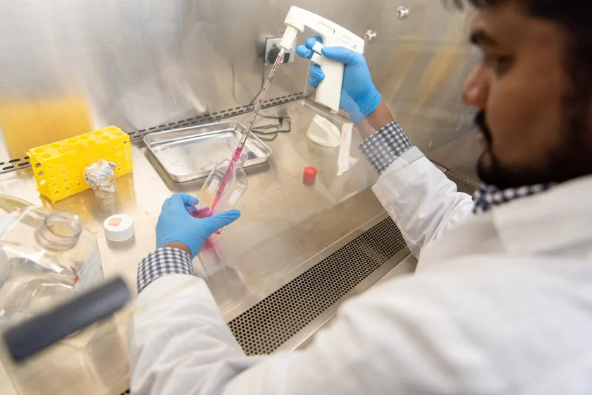 Industrial and Manufacturing Engineering student performing an experiment in a lab