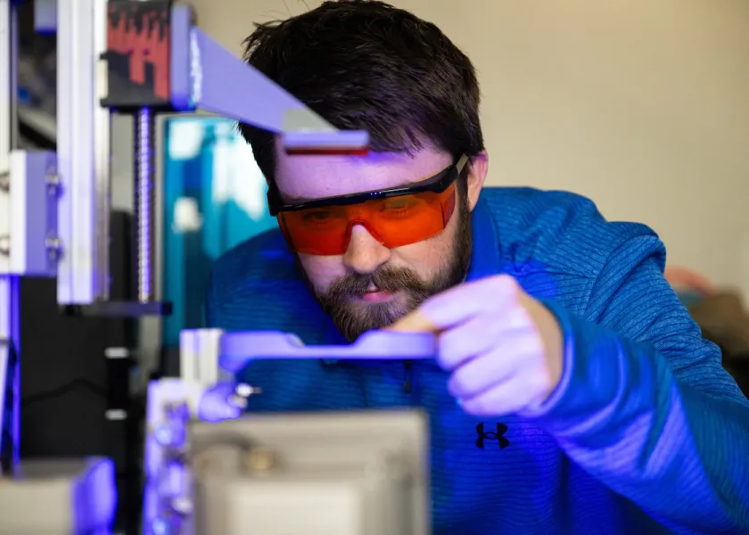 student performing a test in a lab