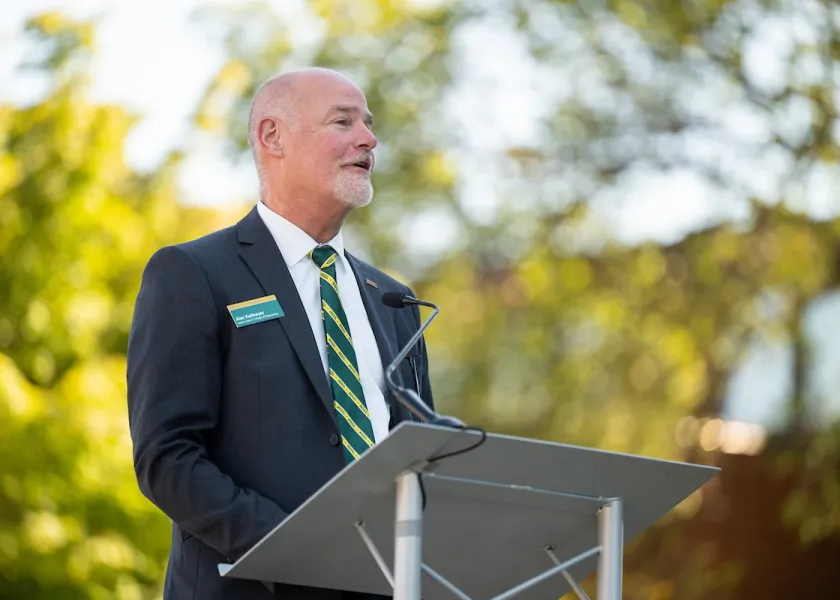 Alan Kallmeyer speaking at a podium.
