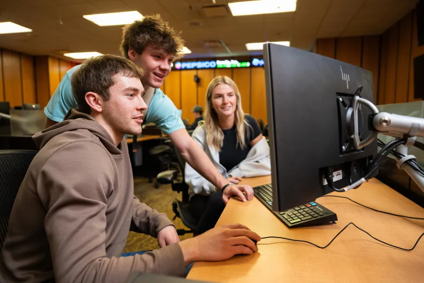 students looking at a computer monitor