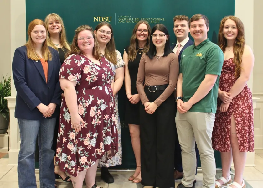 a group photo of the top ten seniors in the College of Agriculture, Food Systems, and Natural Resources standing together at a banquet.