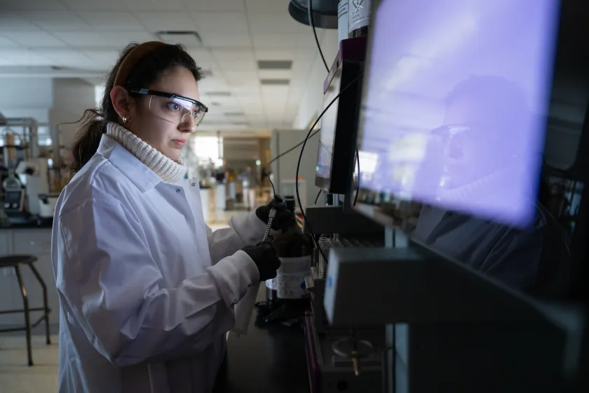 student performing a test in a lab