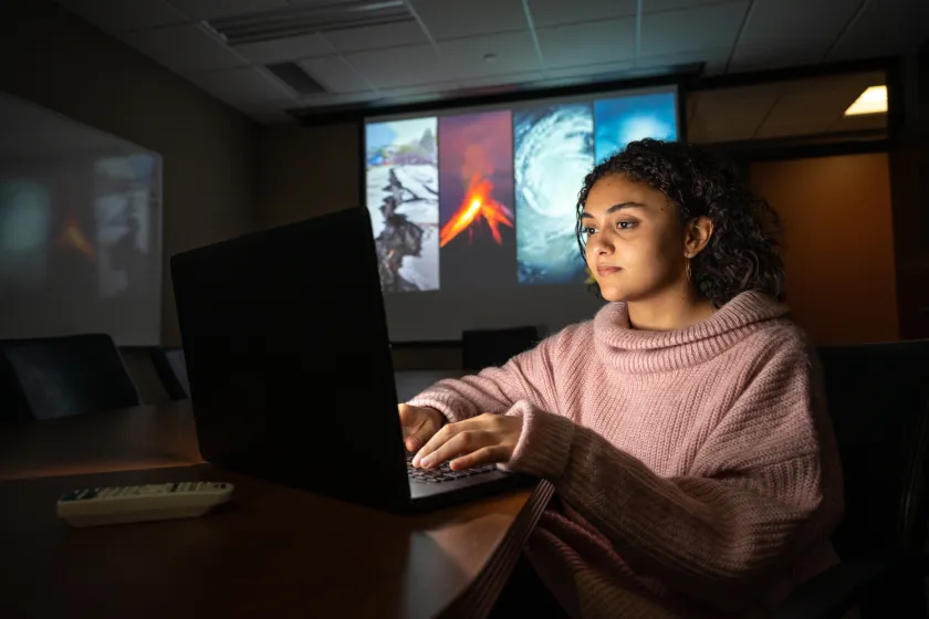 Emergency Management student working on a laptop