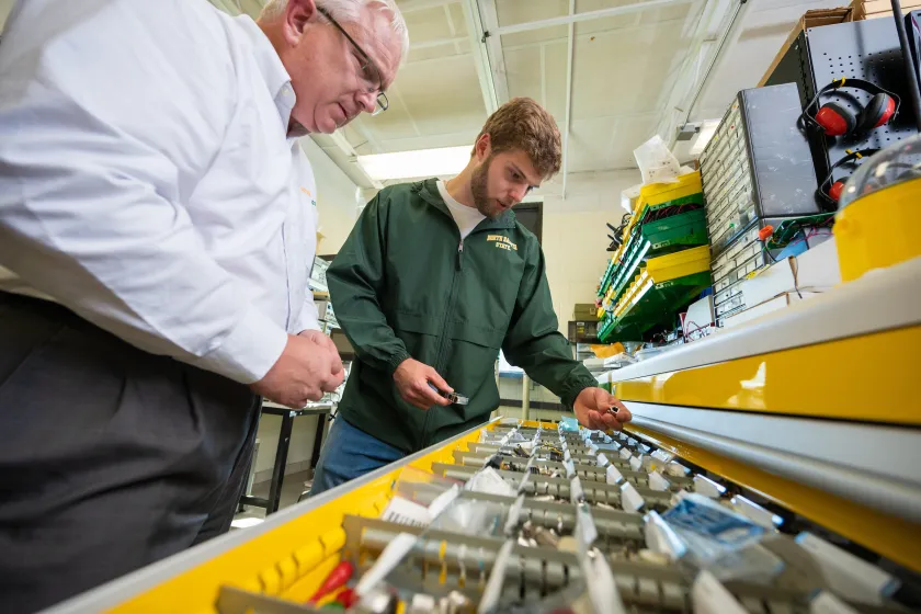student and professor testing computer parts