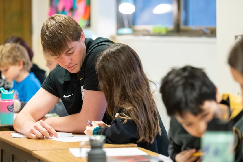 NDSU Education student helping children in the classroom