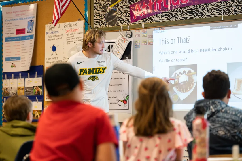 Health Education student giving a presentation to a classroom of young students