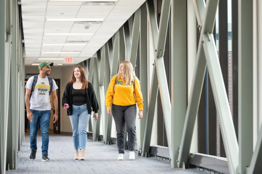 grad students walking through campus building
