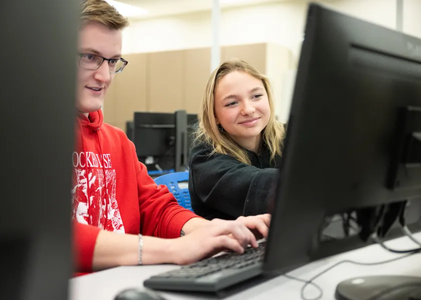 students working on a program in a computer lab
