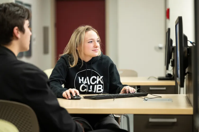 Cybersecurity students working on a project in a computer lab