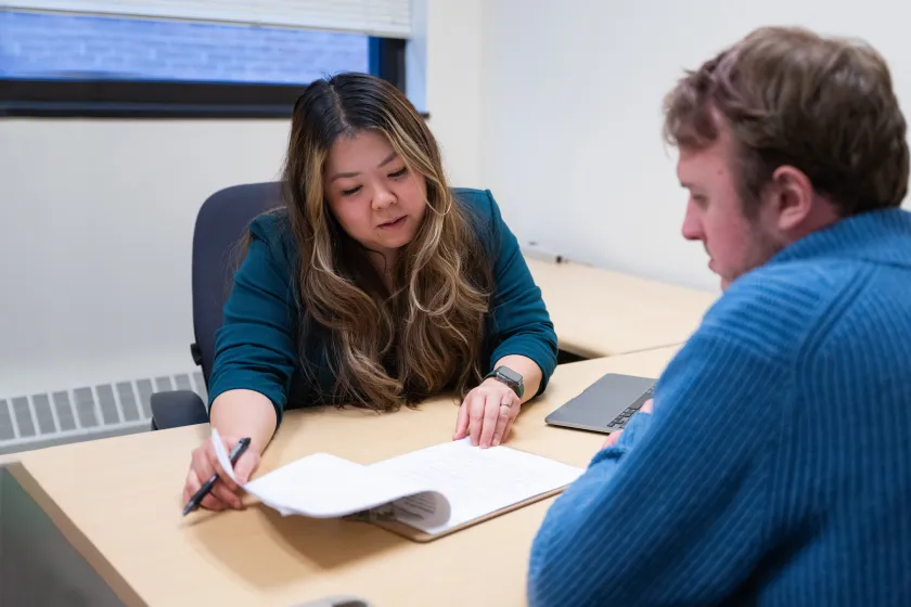 professor meeting with a student to discuss an assignment 