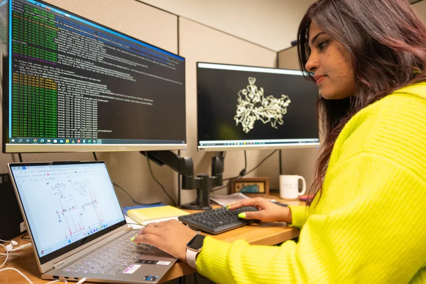 student writing code on a computer