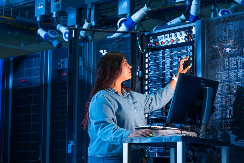student working on a server in a network room