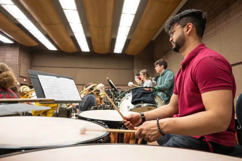 students in the percussion section practicing