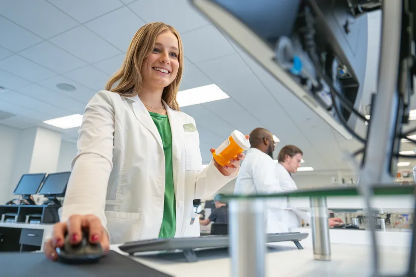 Pharmacy student filling a prescription