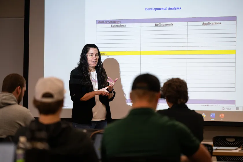 professor presenting a lecture to students in a classroom